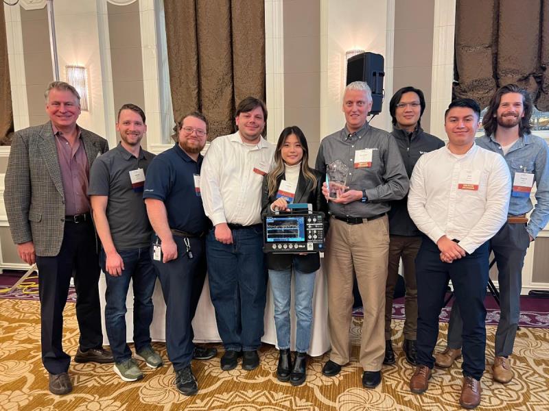 Engineers who developed the 2 Series MSO accepting a new award