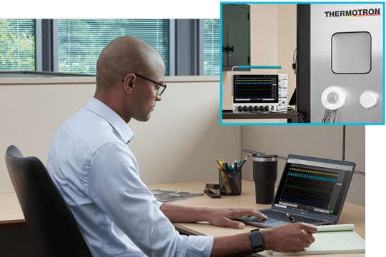 Engineer at his bench working space using remote software to control an oscilloscope and performaning measurements and analysis remotely