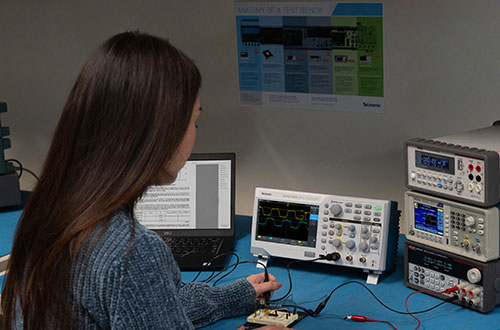 Engineering student learning to test a DUT with the Tektronix TBS1000C education oscilloscope