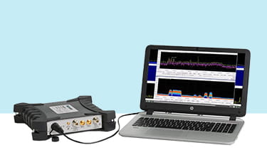 An image of a laptop showing Tektronix DataVu PC software hooked up to a Tektronix RSA signal analyzer.