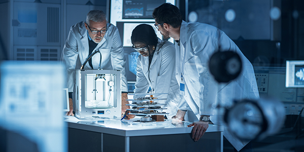 Technicians in high-tech laboratory environment deeply engaged in their work