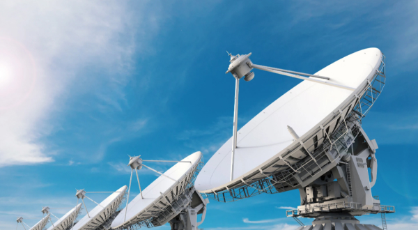 A row of large telecomunication satellite dishes