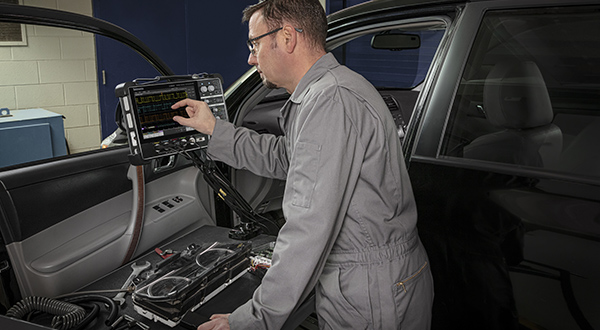 Battery-powered automotive oscilloscope shows signals on test vehicle