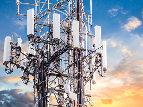 Cellular towers against blue sky for 5G Testing & Calibration