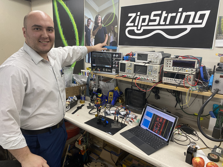 ZipString co-founder shown at his engineering bench featuring the 2 Series MSO oscilloscope.